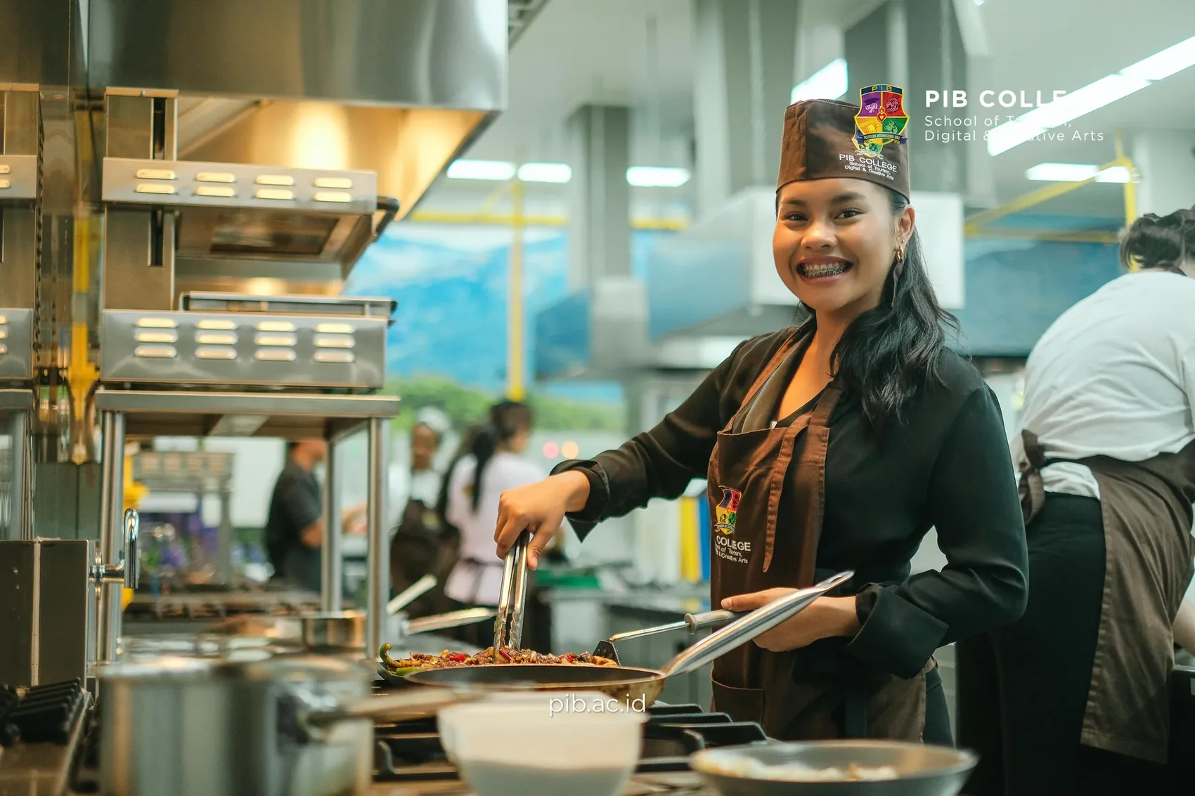 Smiling culinary student frying a dish at the stove
