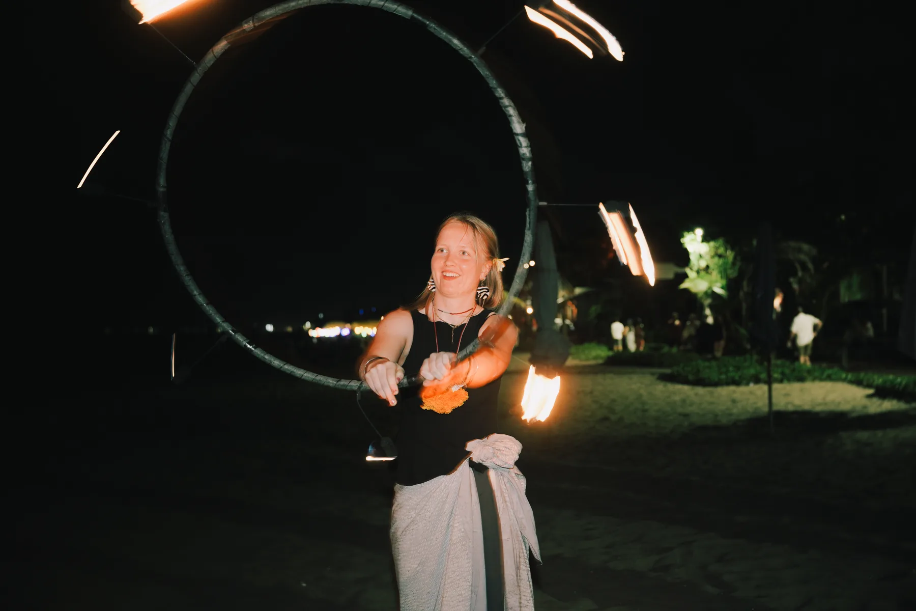 A student spinning a lit fire hoop during the fire show