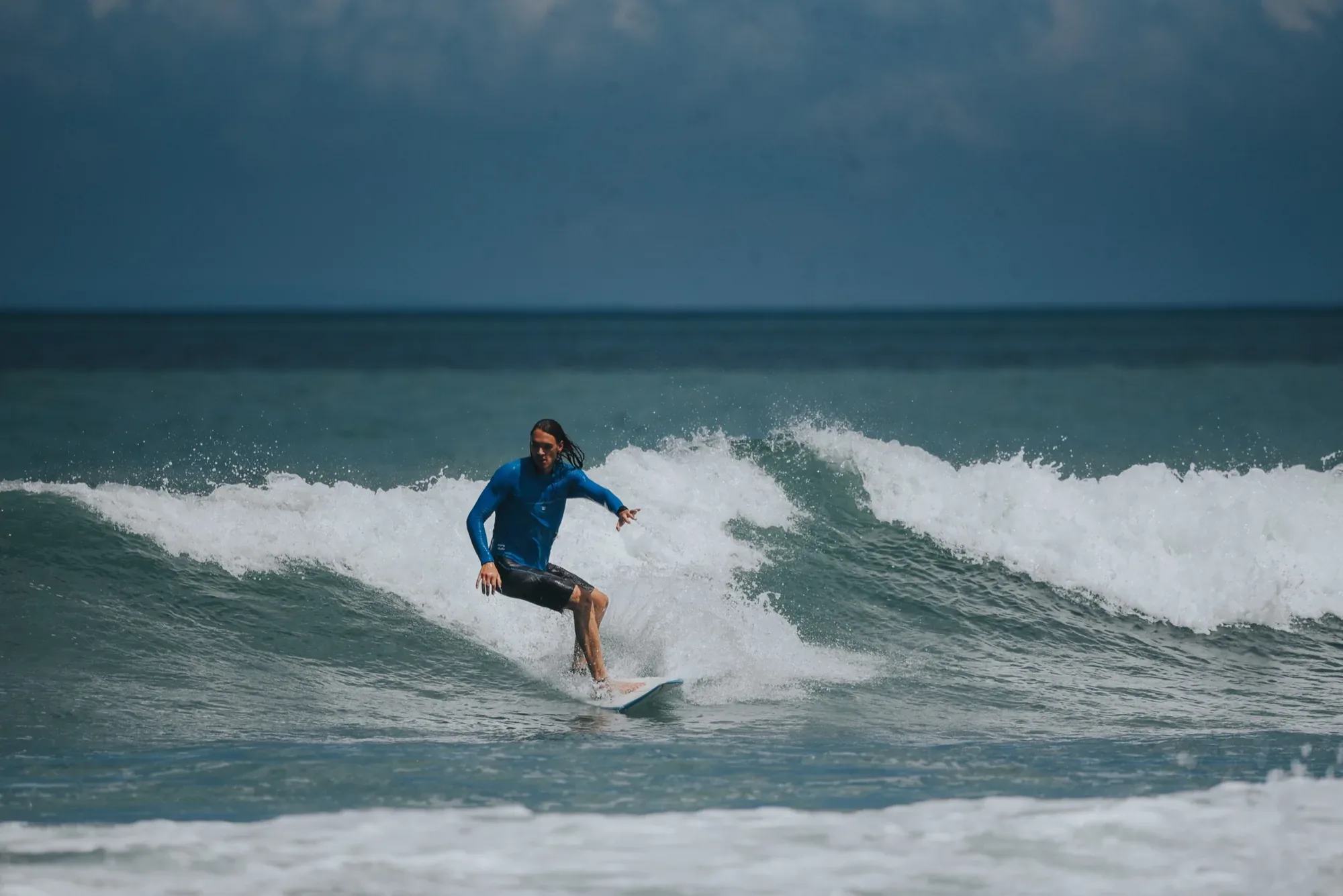 Student surfing a wave in Bali